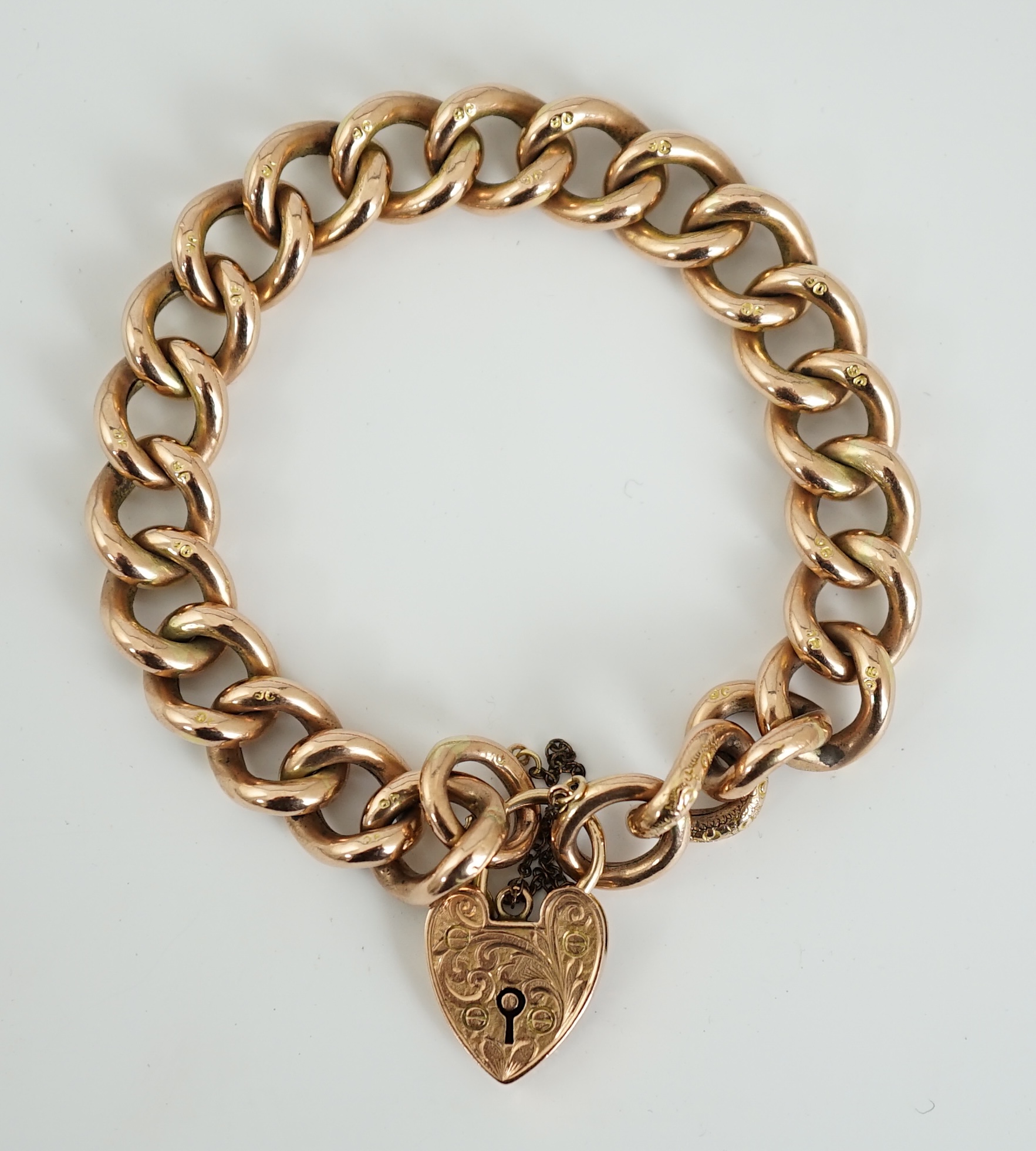 An Edwardian 9ct engraved curb link bracelet, with heart shape padlock clasp